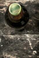 bottle of fresh beer. On wooden background. photo