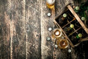 Bottles with beer in an old box. photo