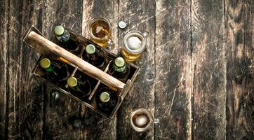 Bottles with beer in an old box. photo