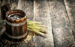 Fresh beer in a wooden mug. photo