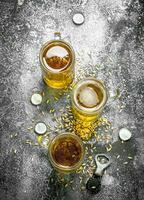 glasses of beer with a bottle opener and stoppers. photo