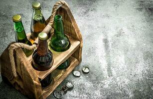 Old box with beer. On rustic background. photo