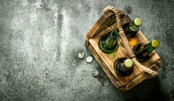 Old box with beer. On rustic background. photo