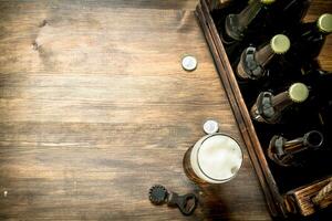 glass of beer with a box and a bottle opener. photo