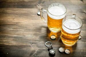 glass of beer with stoppers and a bottle opener. photo