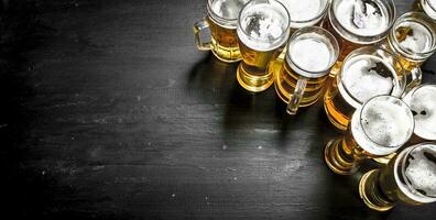 Glasses with beer. On black chalkboard. photo