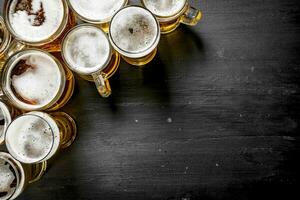 Glasses with beer. On black chalkboard. photo