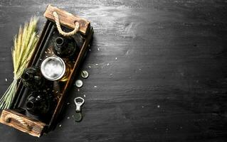 Fresh beer in glasses and in an old box. photo