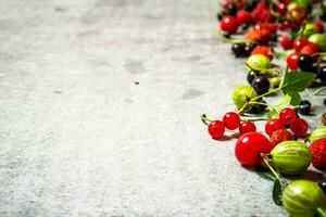 Different berries on the stone table. photo