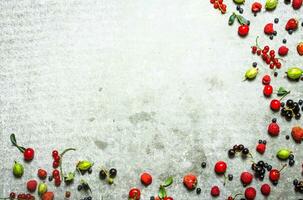 Different berries on the stone table. photo