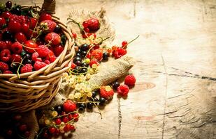 Basket with berries. On wooden table. photo