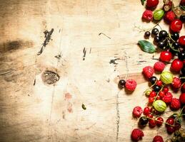 Fresh forest berries .On wooden background. photo