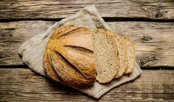 Cut fresh bread on old fabric.  Top view photo