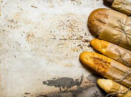 Set fresh bread on rustic background. Free space for text . photo