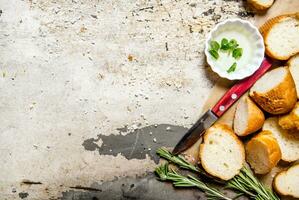 Ciabatta with herbs on paper. On rustic background. photo