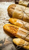 Set fresh bread on rustic background. photo