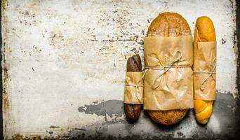 Set fresh bread on rustic background. Free space for text . photo