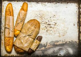 Set fresh bread on rustic background. Free space for text . photo