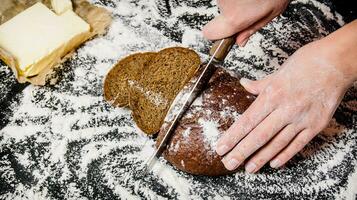 Sliced rye bread on Board with flour. photo