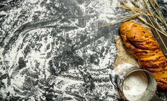 Ciabatta with flour and ears. On Board with flour. photo