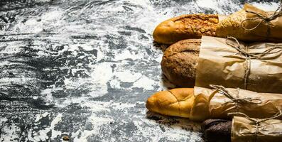 Set of fresh bread wrapped in paper. photo