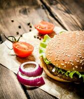 hamburger with fresh tomatoes, onions and spices. photo