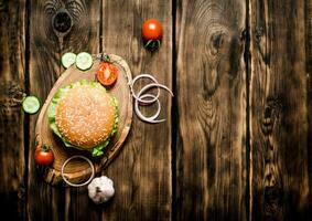 Cooked Burger with vegetables, cheese and meat. photo