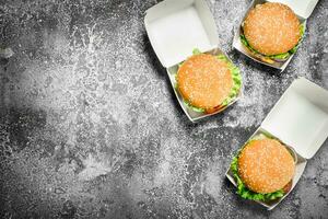 Fresh burgers in paper boxes. photo