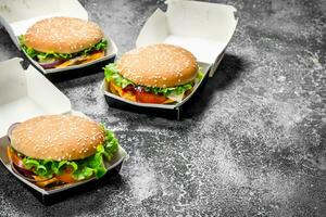 Fresh burgers in paper boxes. photo