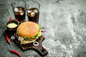 Fresh burger with cola and hot sauce. photo