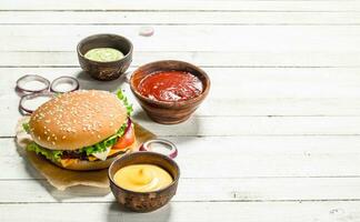 Burger with fresh beef, cheese and vegetables. photo