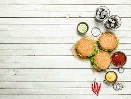 Burgers with cola and various sauces. photo