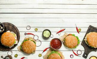 Fast food. Various burgers with beef and fresh vegetables. photo