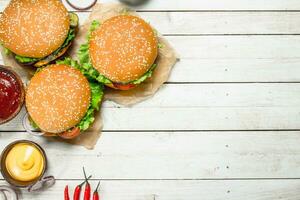 Burgers with fresh beef, cheese and vegetables. photo