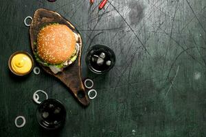 Fast food. Burger with cola and sauce. photo