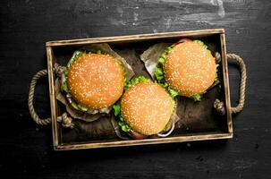 Burgers on an old tray. photo