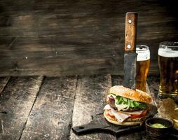 Street food. A big burger with beer. photo