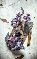 Cut ripe cabbage with a hatchet. photo