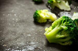 Fresh broccoli on stone table. photo