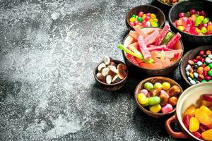 Multicolored candy, jelly and marshmallows in a bowl. photo