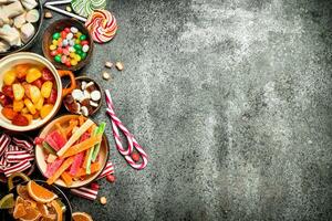 Multicolored candy, jelly and marshmallows in a bowl. photo