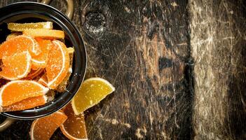 Fruit jelly in bowl. On wooden background. photo