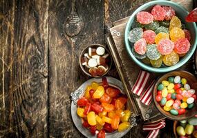 Different sweet candy, jelly, marshmallows and candied fruits. photo
