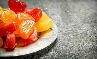 Fruit candies on a steel tray. photo