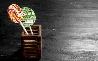 Sweet lollipops in a wooden stand. photo