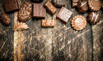 Chocolate candies. On wooden background. photo