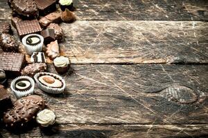 Chocolate candies. On wooden background. photo