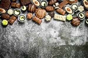 Chocolate candies. On rustic background. photo