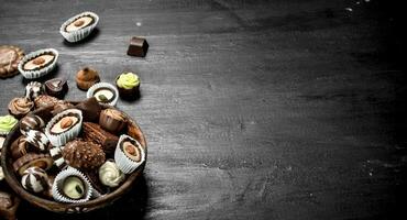 Chocolate candies in a bowl. . photo