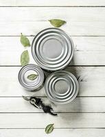 Tin cans with food and opener. photo